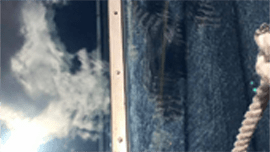 Sun Services technician cleaning residential windows in Central Maine