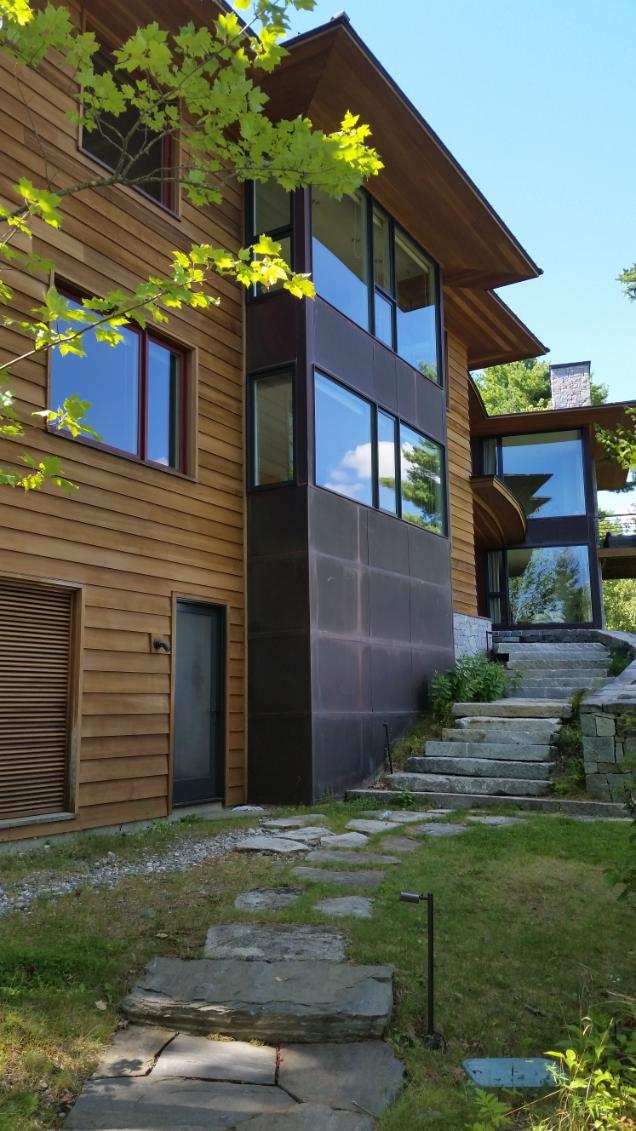 Large residential property with extensive multi-story windows serviced by Sun Services, Inc.